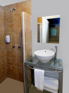 a bathroom with a sink and a shower at Container Inn Hotel Aeropuerto in Puerto Vallarta +80 photos