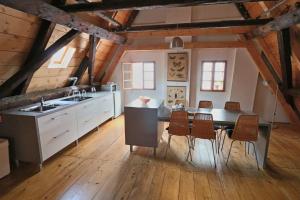 a kitchen with a sink and a table with chairs at Apartment Soukenicka 44 in Český Krumlov