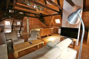 a living room with a couch and a tv at Apartment Soukenicka 44 in Český Krumlov