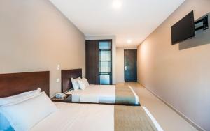 Postel nebo postele na pokoji v ubytování Ribai Hotels - Barranquilla