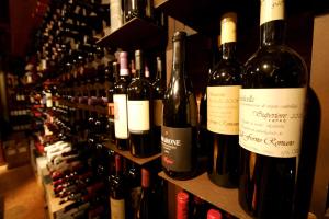 a bunch of wine bottles are lined up on a shelf at La Bussola Da Gino in Quarrata