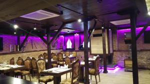 a dining room with tables and chairs and purple lights at Edirne Osmanlı Evleri in Edirne