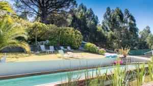 a swimming pool in a yard with trees at Quinta das Leiras in Santo Tirso