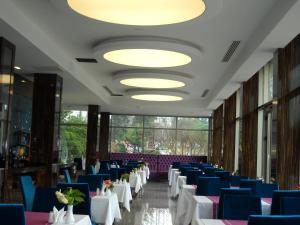 a row of tables and chairs in a room with lights at Buyuk Saruhan Hotel in Manisa