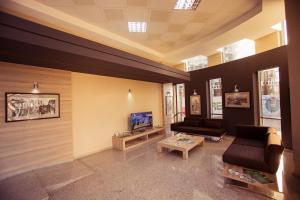 a living room with two couches and a tv at Viva Blue Batumi in Batumi