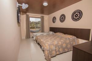 Cama ou camas em um quarto em Pousada Primavera