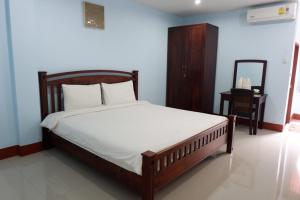 a bedroom with a bed and a mirror in it at Na Chaidej hotel in Suratthani +41 photos