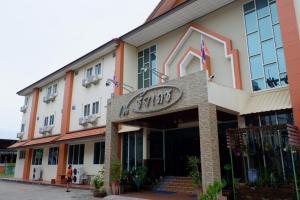 a person standing outside of a hotel at Na Chaidej hotel in Suratthani