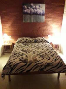 Una cama o camas en una habitación de Hotel de Campo El Rebenque