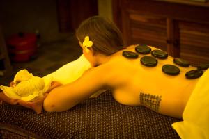 a woman laying on a bed with a video game controller at Golden Temple Villa in Siem Reap