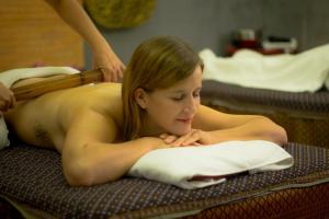 a woman laying on a bed in a massage at Golden Temple Villa in Siem Reap