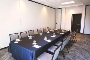 a conference room with a long table and chairs at Hyatt Place Austin Airport in Austin