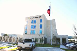 a white truck parked in front of a building at Hyatt Place Austin Airport in Austin