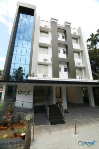 a large building with stairs in front of it at Omnest in Cochin