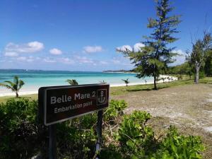 a sign in front of a beach with the ocean at Eden Villa in Belle Mare