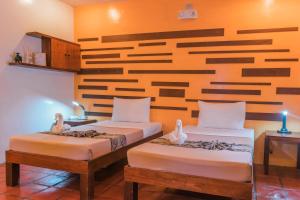 Posteľ alebo postele v izbe v ubytovaní Acacia Tree Garden Hotel