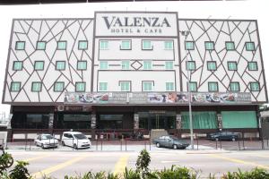 a hotel with cars parked in front of it at Hotel Valenza in Kuala Lumpur
