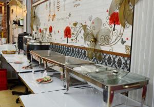a kitchen with a row of tables in a restaurant at At Bangkok Hotel in Bangkok