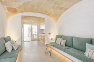 a living room with a couch and a table at Holiday Home Casa Sa Font by Mauter Villas in Ciutadella