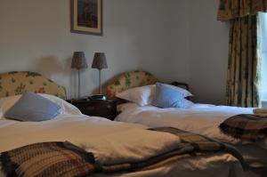 two beds sitting next to each other in a room at Rose Cottage in Tunstall