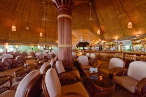 a restaurant with chairs and tables and a bar at Thulhagiri Island Resort & Spa in North Male Atoll