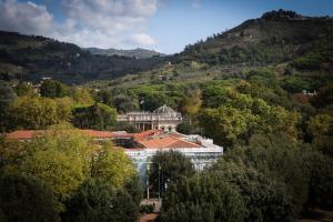 a building in the middle of a forest of trees at Grand Hotel Tettuccio in Montecatini Terme