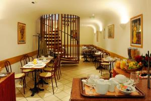 a restaurant with tables and chairs and a staircase at Auriane Porte De Versailles in Paris