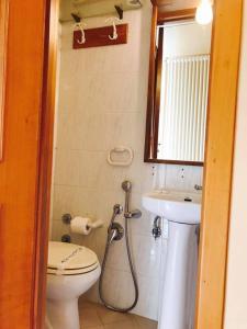 a bathroom with a toilet and a sink at Corato room economy in Corato +17 photos