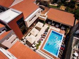 an overhead view of a swimming pool on a building at Hotel Borovnik in Tisno