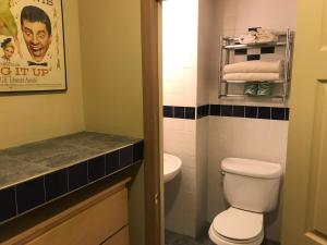 a bathroom with a toilet and a sink at Chelsea Pines Inn in New York