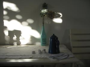 a vase with flowers in it sitting on a table at Apartment Tanja in Supetar +25 photos