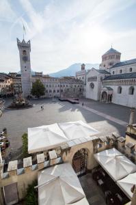 a large building with a clock on top of it at Scrigno del Duomo in Trento