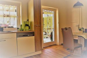a kitchen with a table and a chair next to a window at FeWo Lermann Marktheidenfeld in Marktheidenfeld
