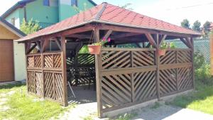 a wooden gazebo with a red roof at Privát pu Bartolomeja in Štrba