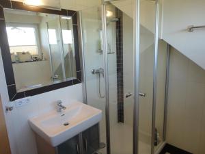 a bathroom with a sink and a shower at Bauernhof Strumegg in Hof bei Salzburg