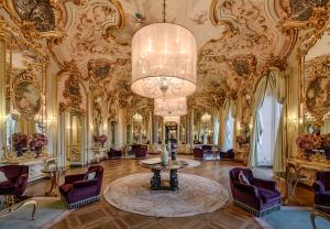 a large room with a chandelier and ornate ceilings at Villa Cora in Florence