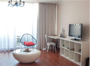 a living room filled with furniture and a tv at Hotel Central Boutique in Marbella