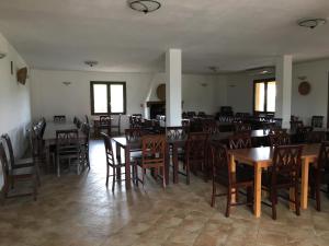 a dining room with wooden tables and chairs at Agriturismo Montealma in Nulvi