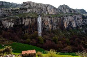 a waterfall on the side of a mountain at Hotel La Alfonsina in Santibáñez de Villacarriedo