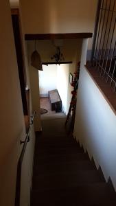 a hallway with a staircase leading up to a room at Dimora Fra' Giovanni B&B Relais in Magione