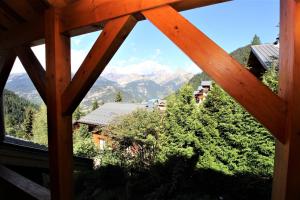 a view of the mountains from a window of a cabin at Chalet Deleglise 2 in Valfréjus