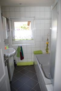 a bathroom with a sink and a toilet and a window at FeWo Marktheidenfeld in Marktheidenfeld