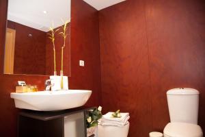 a bathroom with a sink and a toilet at Dean Dos Catedrales in Zaragoza +32 photos