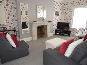 a living room with a couch and a fireplace at Special seafront apartment in Portsmouth