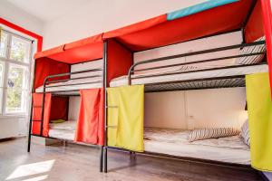 a bunk bed room with three bunk beds in it at Pal's Mini Hostel in Budapest