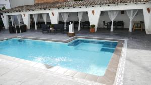 a large blue swimming pool in front of a building at Hotel Salomé in Calafell