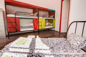 a room with two bunk beds and a bed at Pal's Mini Hostel in Budapest