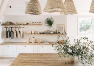 a room with white walls and shelves with a potted plant at The Surfrider Malibu in Malibu