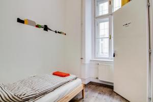 a small bedroom with a bed and a window at Pal's Mini Hostel in Budapest