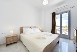 Postel nebo postele na pokoji v ubytování Sun View Villas